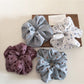 Close-up of Gifty scrunchie showing detailed floral and polka dot design
