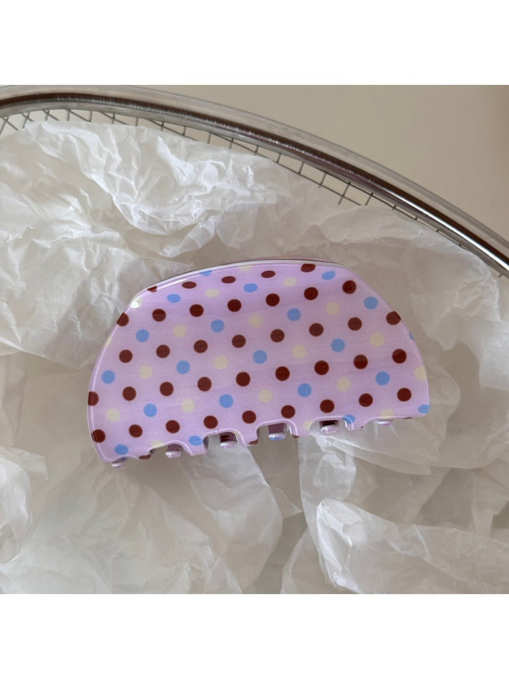 Beau pink polka dot hair clip attached to brown hair