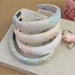 Gifty flower headband displayed on a white background highlighting floral embroidery
