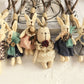 Bunny pendant keychain hanging from a set of keys on a wooden table