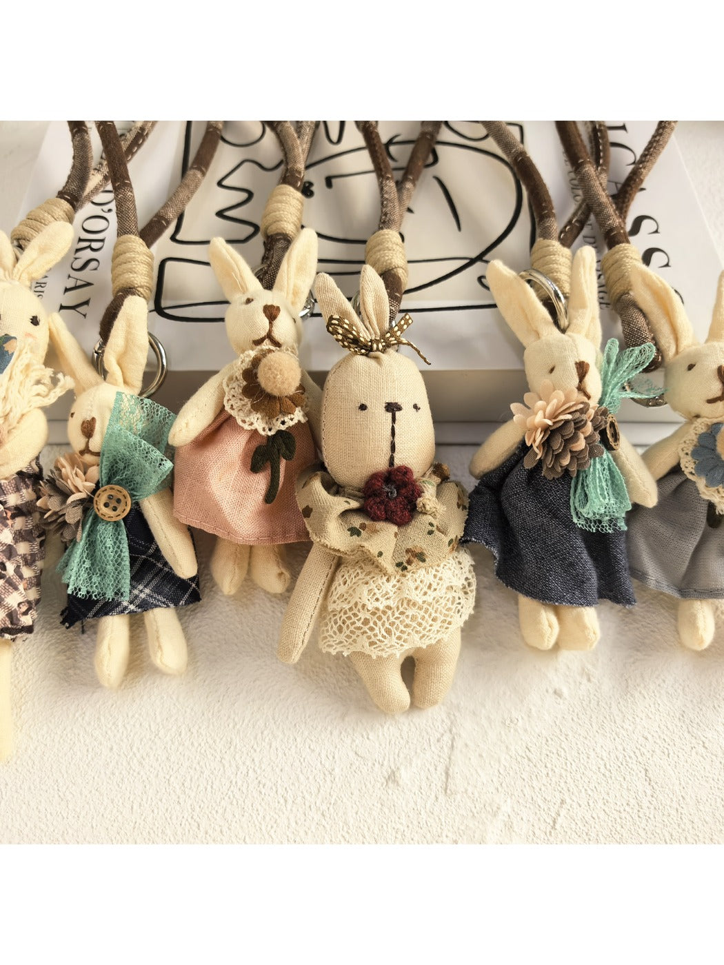 Bunny pendant keychain hanging from a set of keys on a wooden table