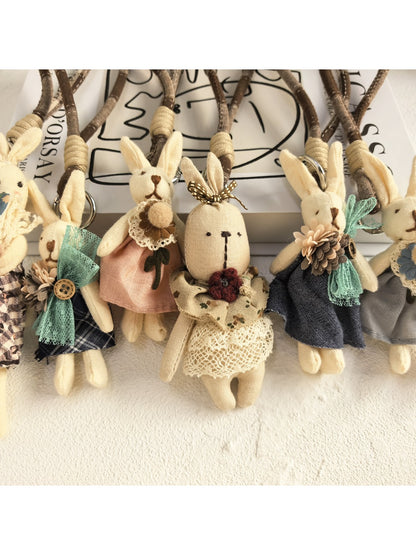Bunny pendant keychain hanging from a set of keys on a wooden table