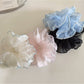 Gifty ruffled scrunchie worn on a wrist showing its texture and color