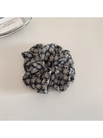 Gifty scrunchie wrapped around ponytail highlighting floral design