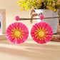 Earedge sunflower earrings shown with matching accessories on a neutral background