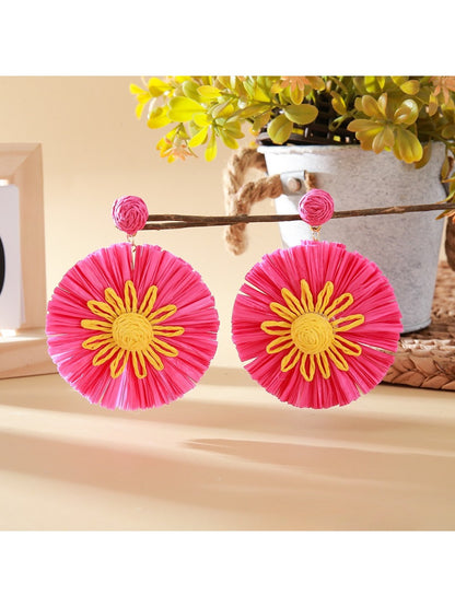Earedge sunflower earrings shown with matching accessories on a neutral background