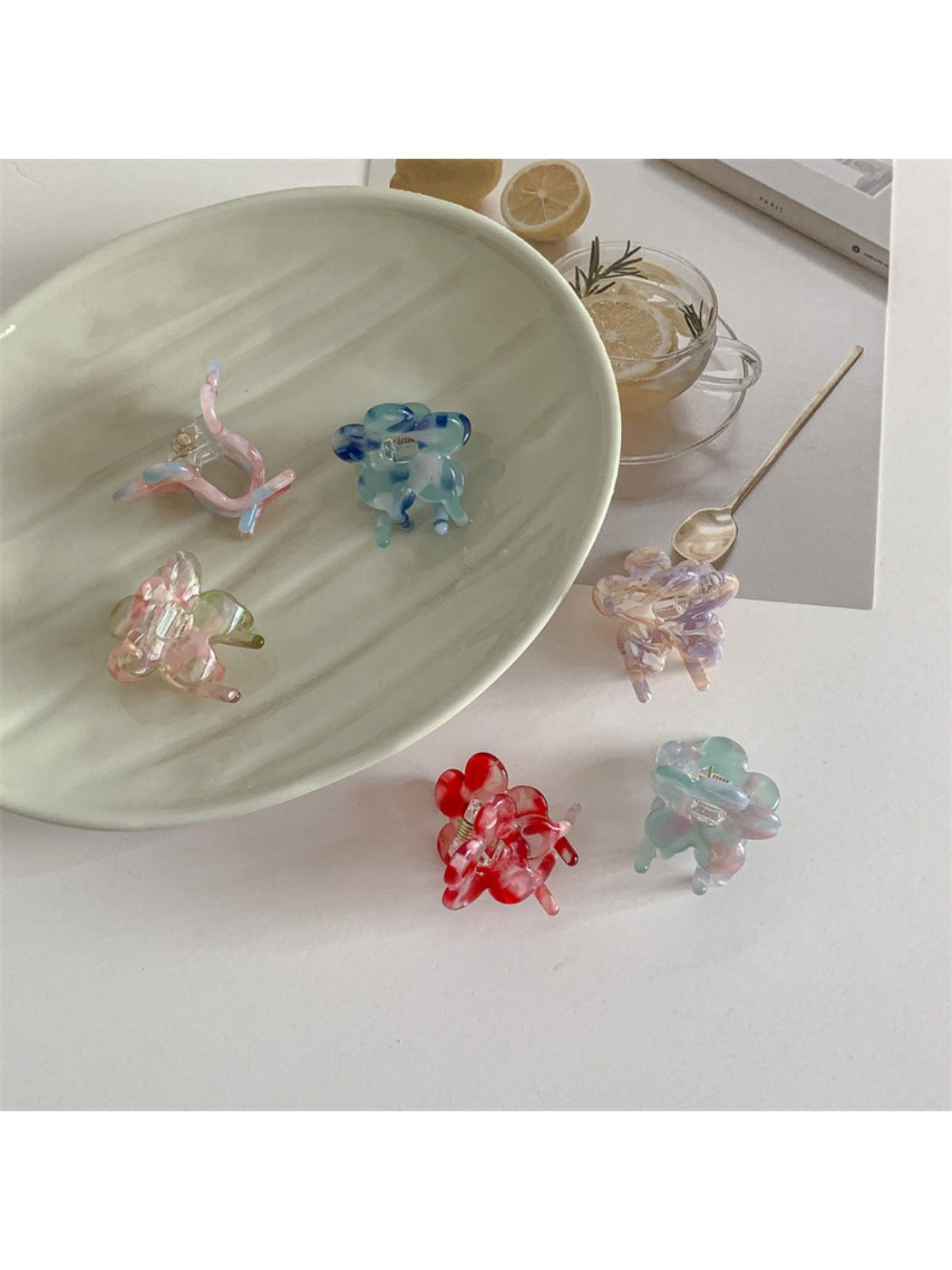 Beau small flower claw clip held in hand displaying size and shape