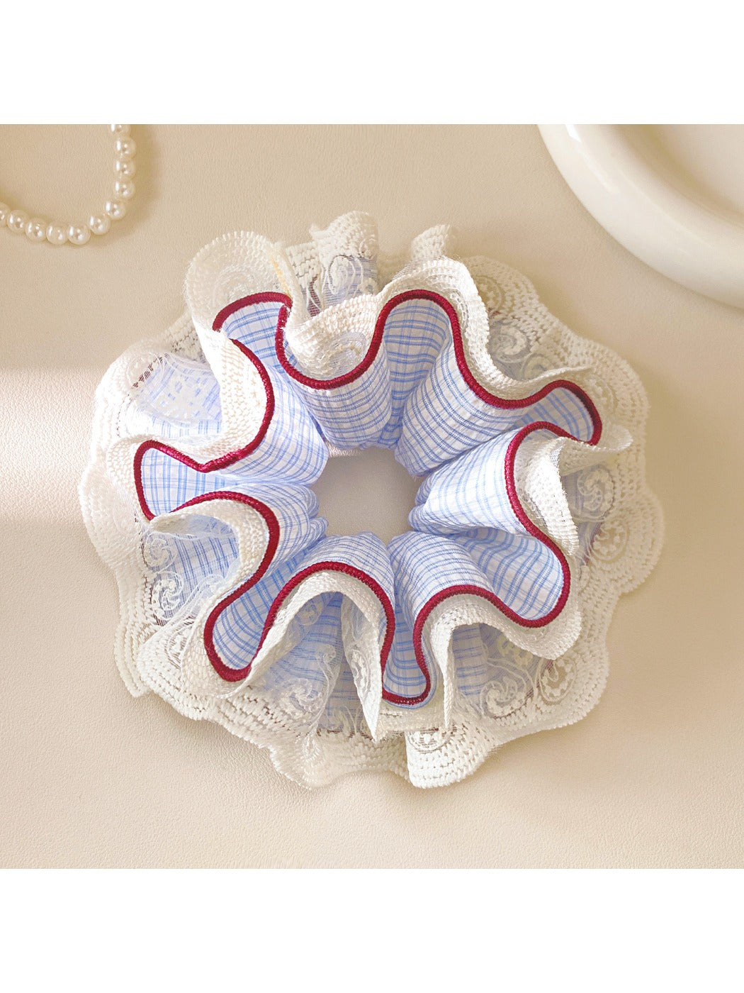 Close-up of Gifty plaid scrunchie showing lace detail and fabric texture