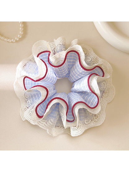 Close-up of Gifty plaid scrunchie showing lace detail and fabric texture