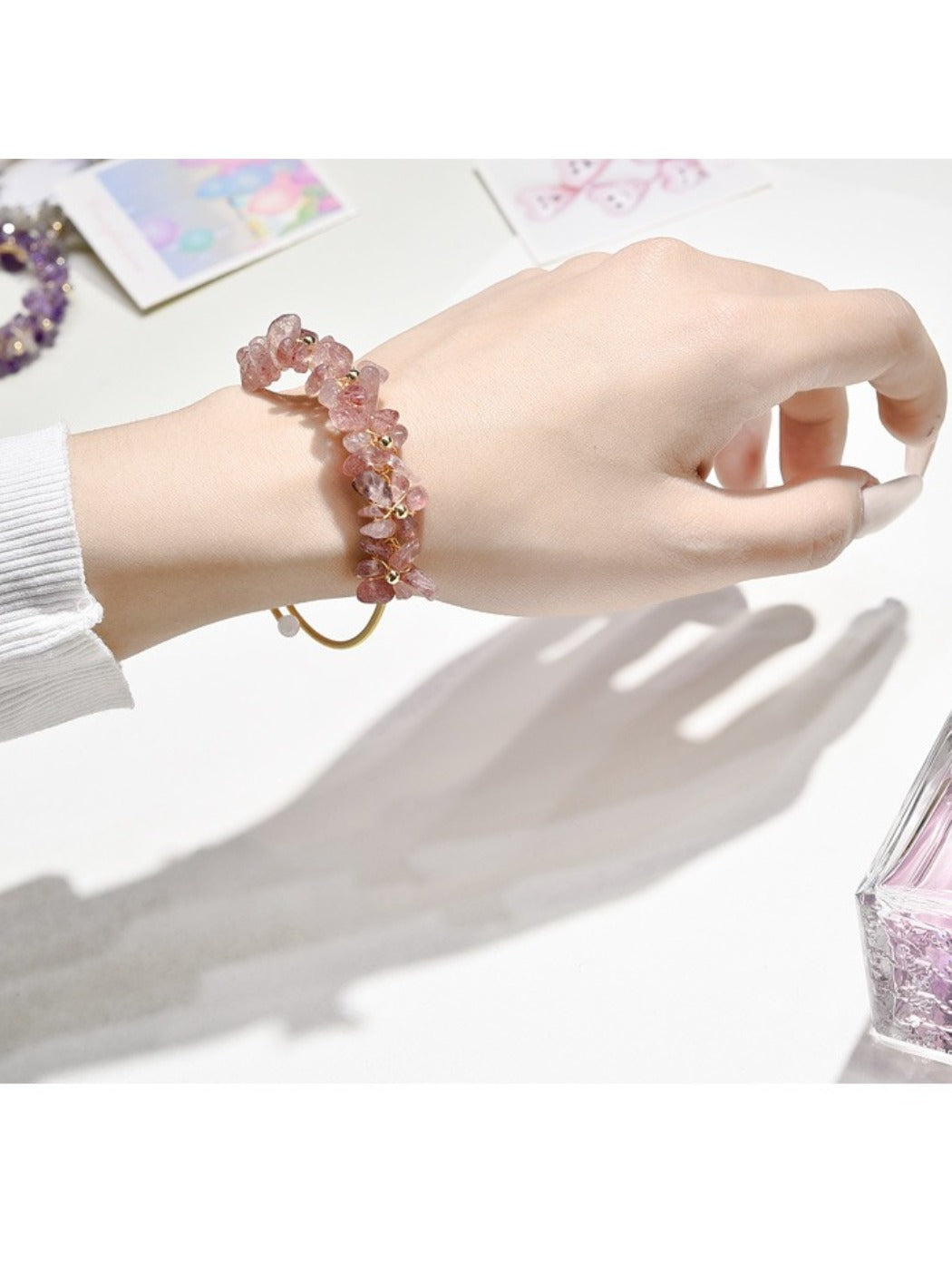 Close-up of Lovra crystal charm bracelet showing detailed charms