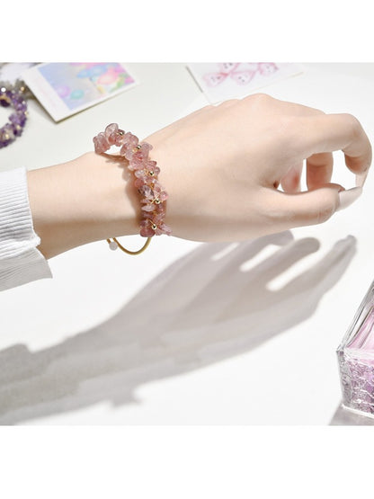 Close-up of Lovra crystal charm bracelet showing detailed charms