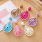 Close-up of Earedge stylish raffia teardrop shaped earrings on white background