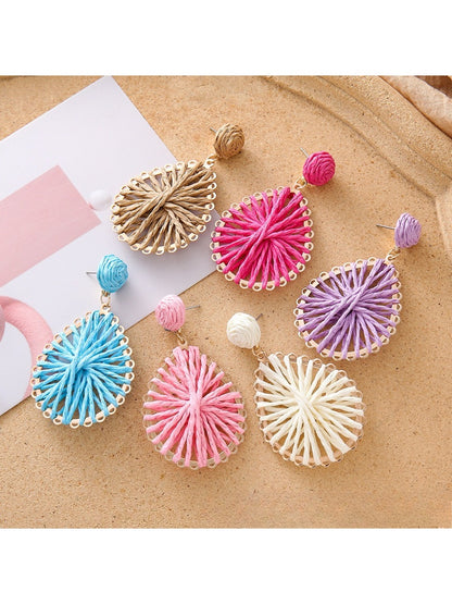Close-up of Earedge stylish raffia teardrop shaped earrings on white background