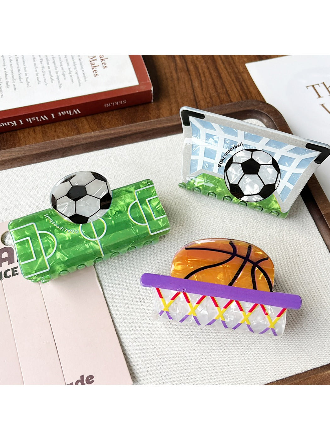 Side view of Beau claw clip featuring a basketball design with textured surface