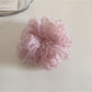 Gifty ditsy floral print scrunchie shown in natural light emphasizing soft fabric