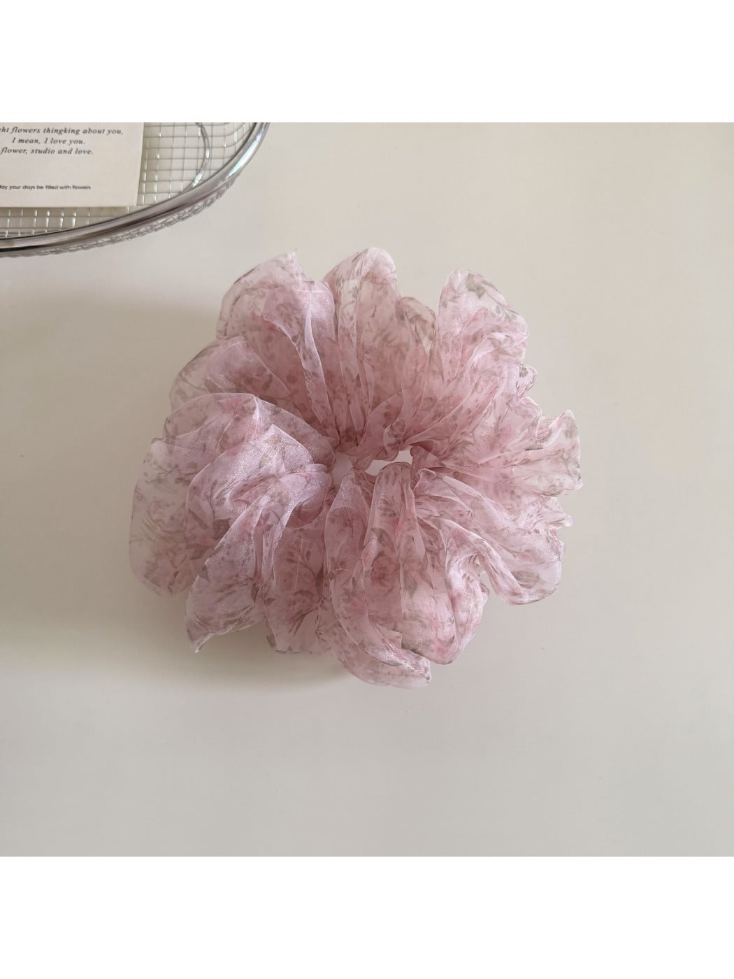 Gifty ditsy floral print scrunchie shown in natural light emphasizing soft fabric