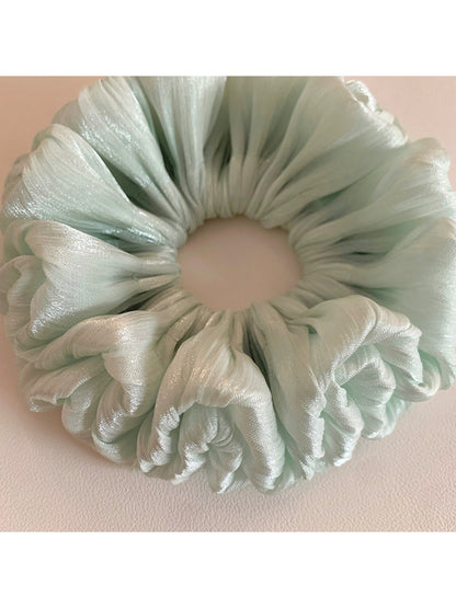 Green double layered scrunchie displayed on a white background