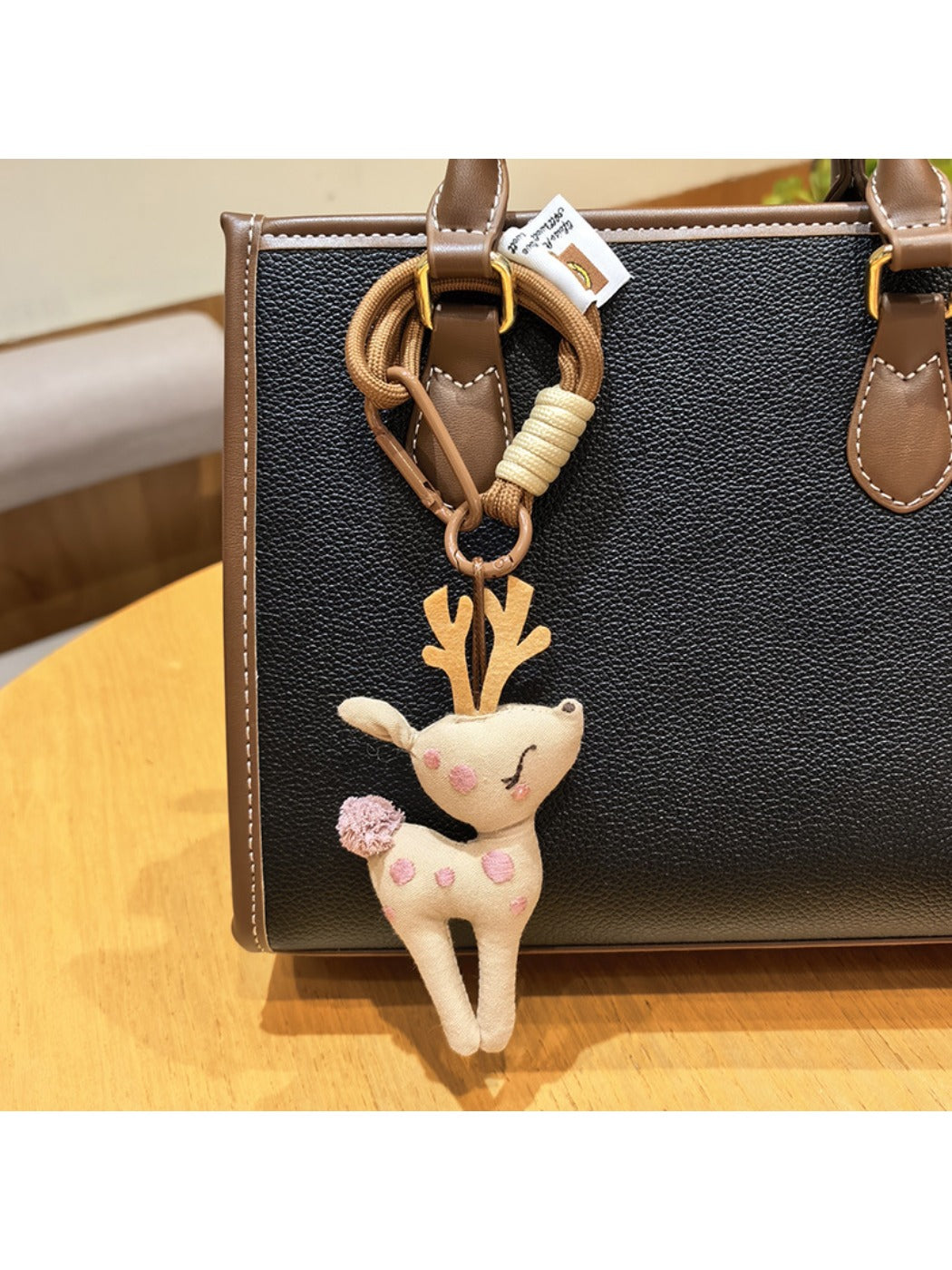 Keypus deer charm keychain with a smiling deer face and small antlers