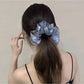 Gifty satin scrunchie showing ruched texture and layered design