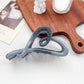 Beau heart shaped bow claw clip with ombre effect displayed alongside matching jewelry