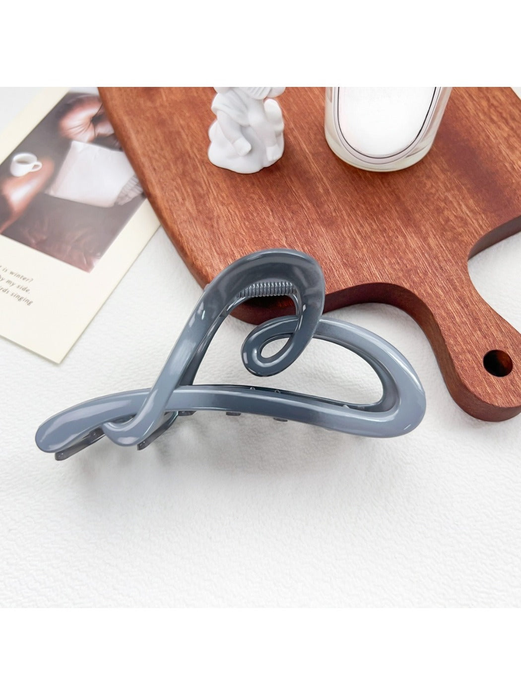 Beau heart shaped bow claw clip with ombre effect displayed alongside matching jewelry