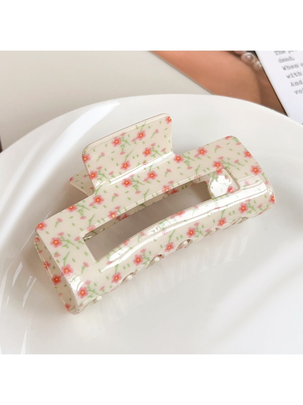 Beau floral print square hair claw clip displayed on a wooden surface