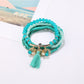 Detailed shot of Lovra bracelet’s metal tassel pendant and multicolored beads