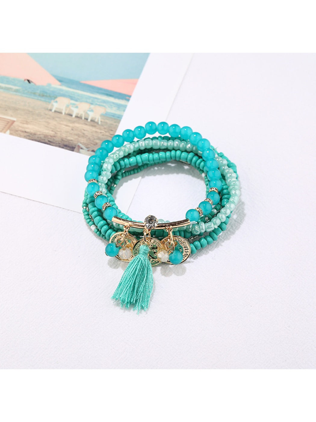 Detailed shot of Lovra bracelet’s metal tassel pendant and multicolored beads