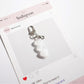 Keypus bag charm keychain held in hand to show size and scale