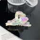 Beau floral hair claw clip photographed with soft shadows on white background
