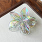 Beau flower shaped claw clip in pink with metal spring visible