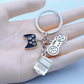 Keypus game controller shaped keychain in black with colorful buttons on a white background