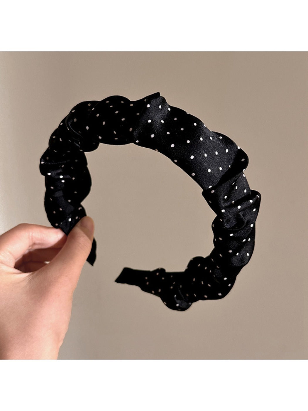 Gifty headband displayed flat showing full pleated design and polka dot print