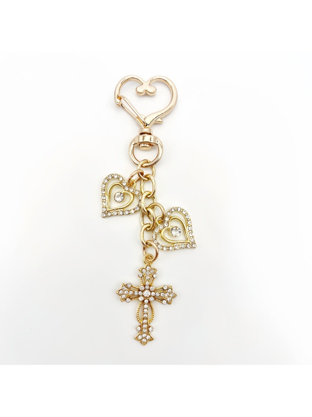 Keychain with vintage cross pendant held in a hand for scale