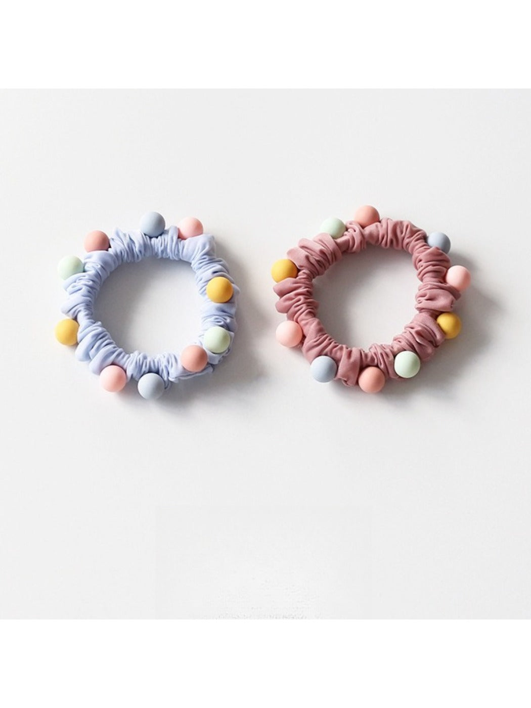 Colorful beaded hair ties stacked together highlighting the variety of colors