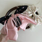 Beau Sweet Tiny Floral Bow Claw Clip held in hand showing size and detail