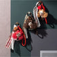 Close-up of fabric doll keychain showing detailed curly hair and embroidered features