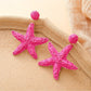 Earedge starfish earrings worn on a model's ear