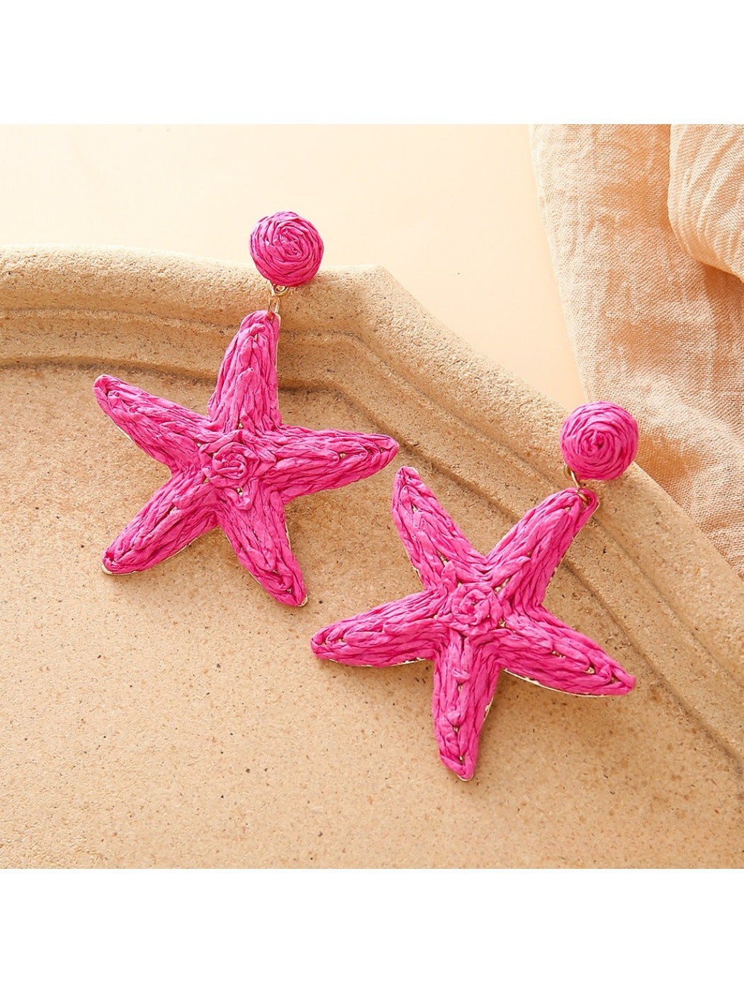 Earedge starfish earrings worn on a model's ear