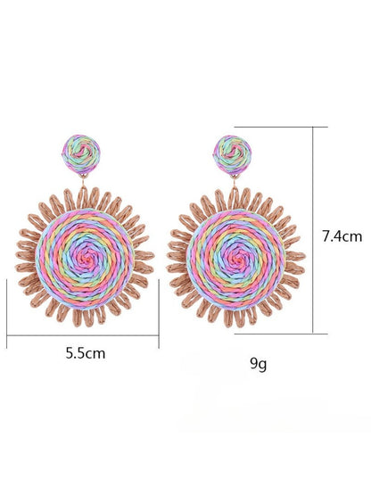 Earedge raffia round earrings displayed on a wooden surface