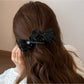 Close-up of the bow design on the Beau Sweet Bow Banana Clip in beige