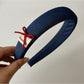 Blue scrunchie and headband packaged together in clear plastic