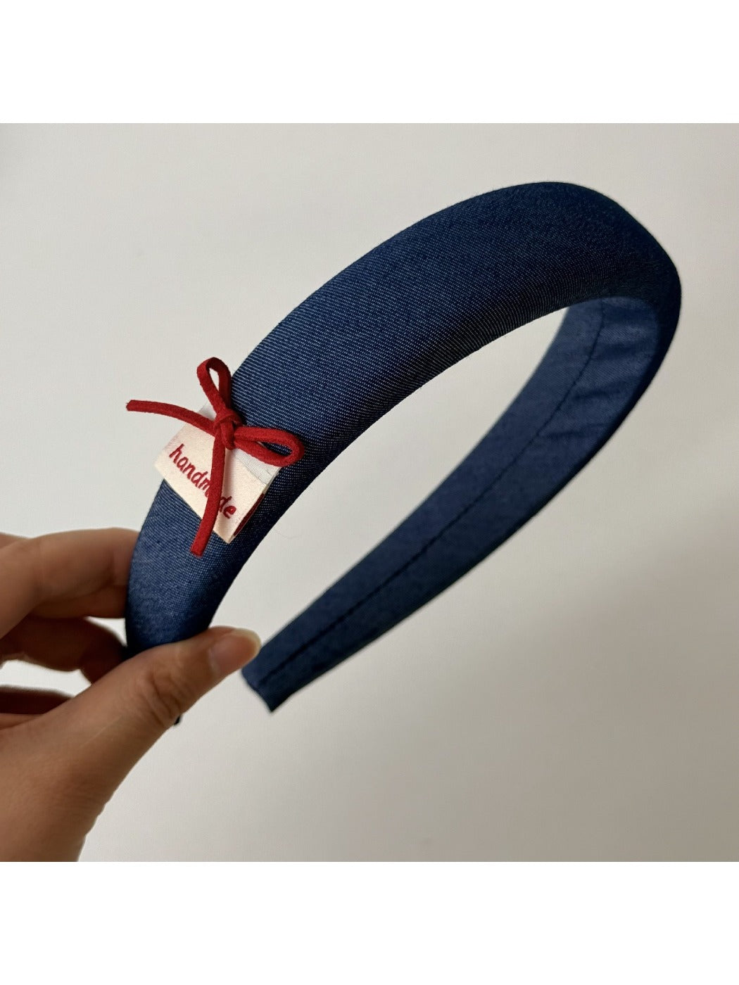 Blue scrunchie and headband packaged together in clear plastic
