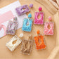 Close-up of Earedge raffia square shape drop earrings on white background