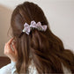 Side view of Beau satin bow banana clip highlighting curved clip design