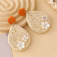 Model wearing Earedge raffia woven teardrop shaped earrings with casual outfit
