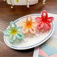Side view of Beau classic flower hair claw clip highlighting curved shape