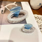 Beau ring shape claw clip open, displaying spring mechanism