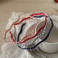 Thin wavy headband with black and white polka dot pattern on fabric