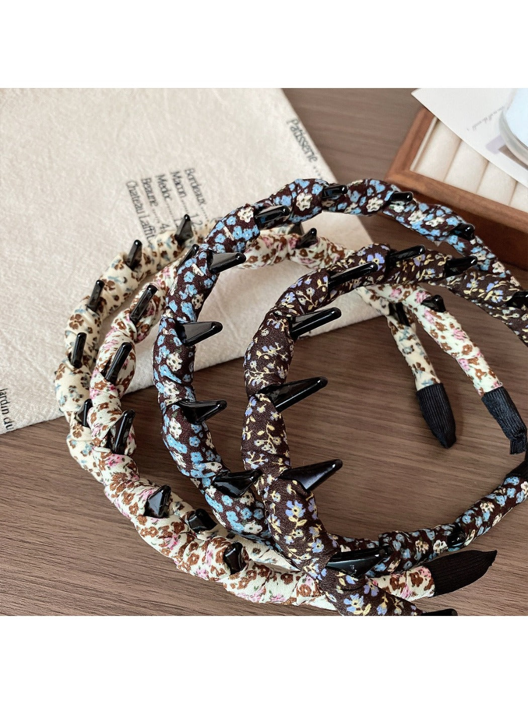 Side view of floral print headband showing elastic back for comfortable fit